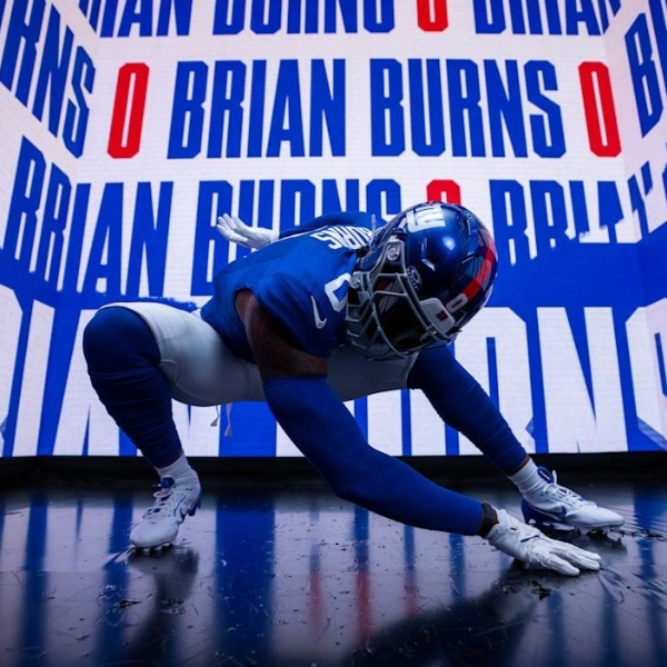 Brian Burns A football player in blue and white uniform strikes a dynamic pose against a digital backdrop displaying the name Brian Burns in bold letters.