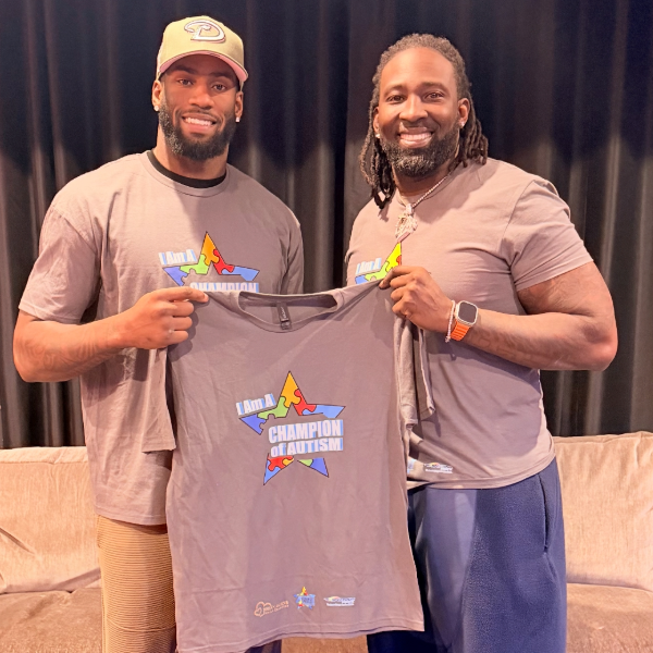 Stanley and Brian holding Hype 4 Life Foundation T-shirt.