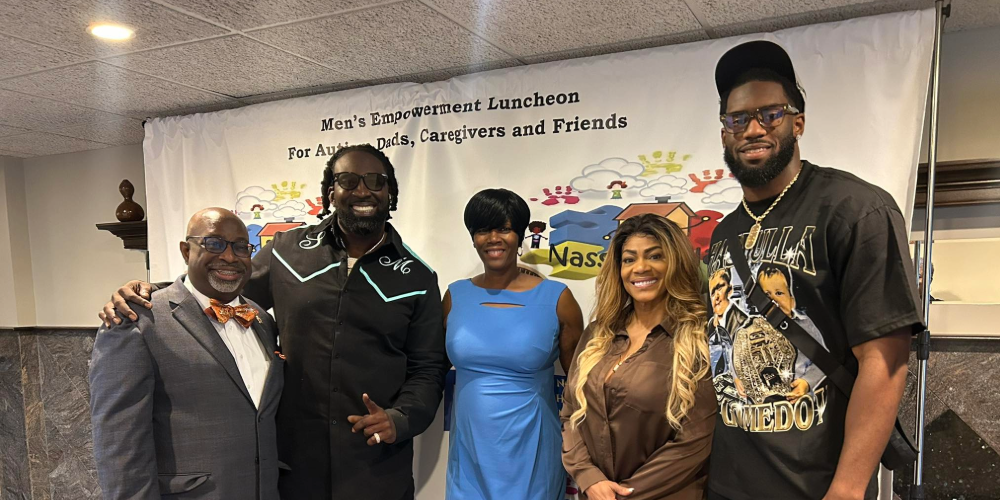 Five people standing in front of Hype 4 Life Foundation event banner.